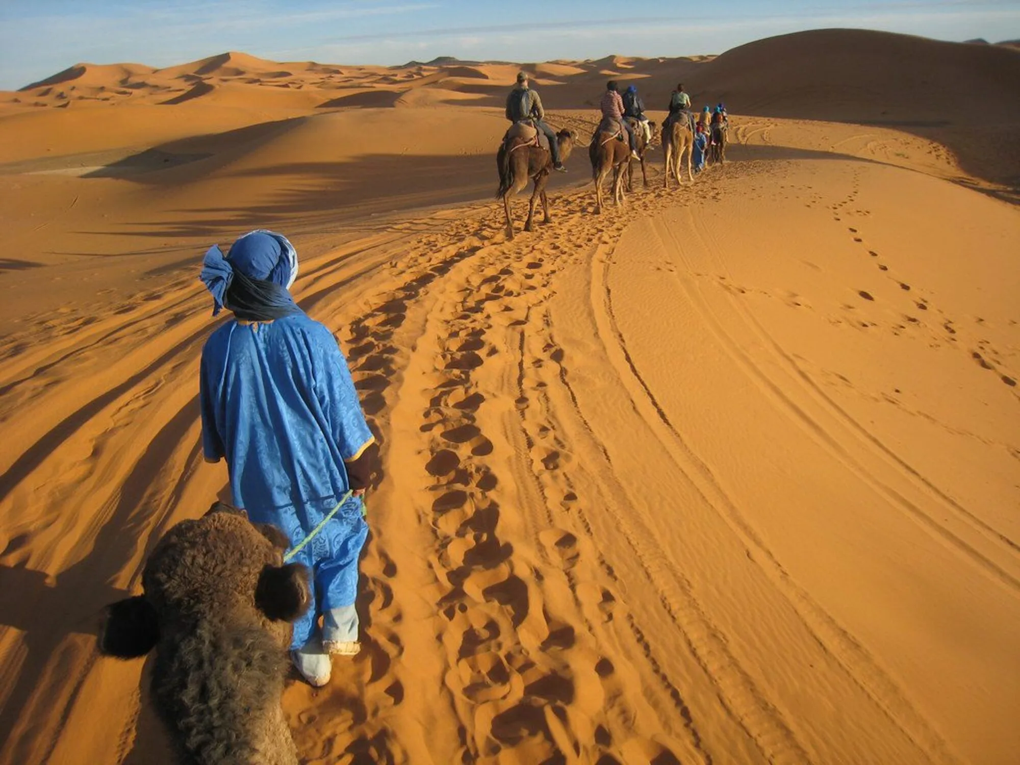 Morocco itinerary – camel ride in the Sahara Desert during sunset with Explore Morocco Trips”