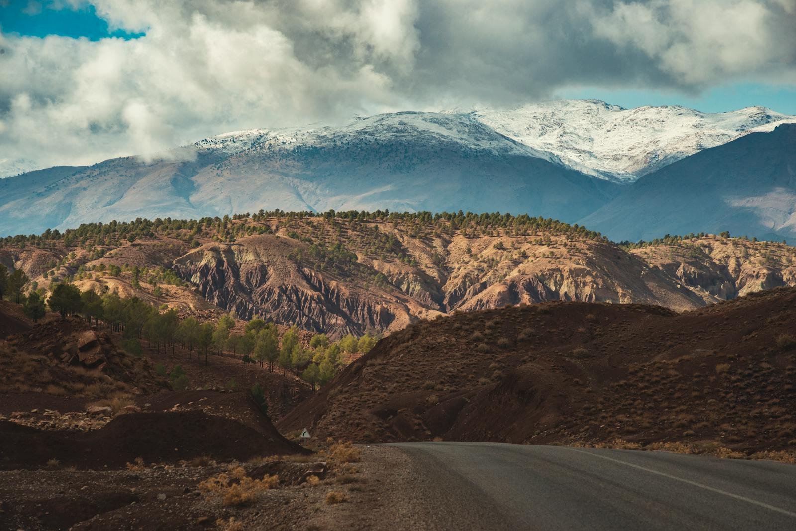 Explore the breathtaking mountain scenery of Ouarzazate, Morocco with winding roads and dynamic landscapes.