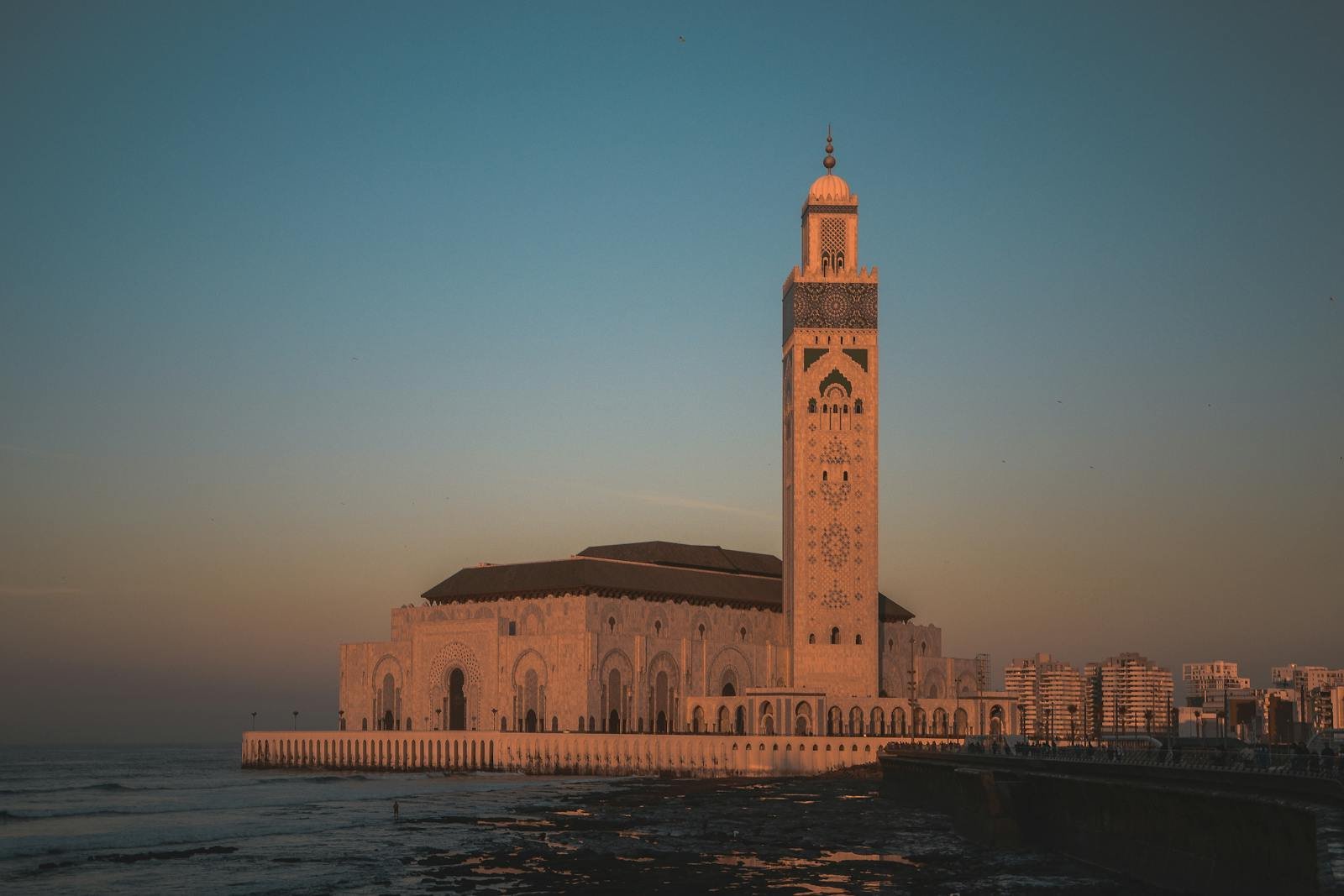 Stunning view of Hassan II Mosque against the sunset sky in Casablanca, Morocco itinerary from casablanca